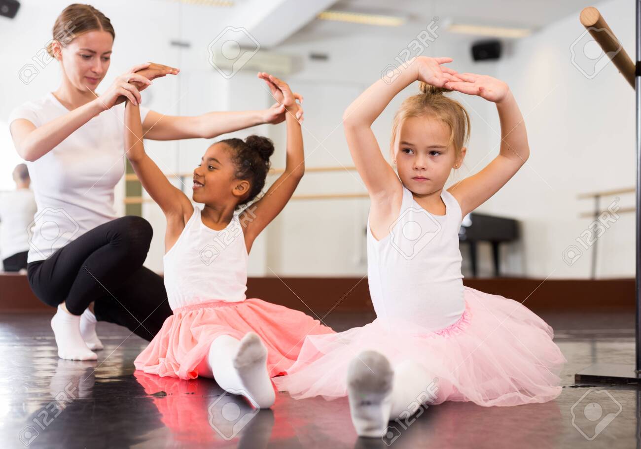 dance teacher helping her little girls students