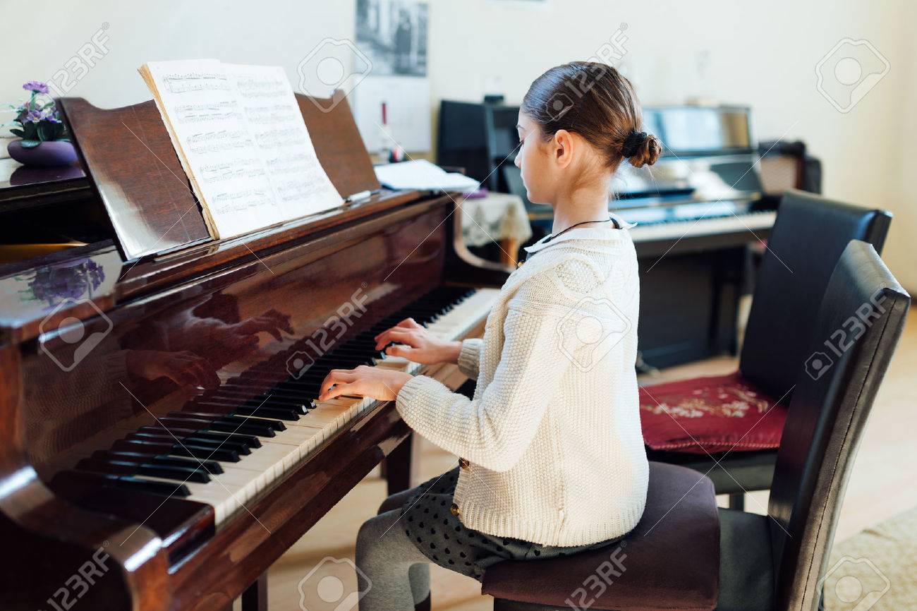 52339594 good student plays the piano at a music school